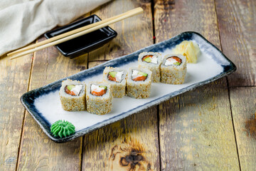 Alaska roll on plate on wooden table