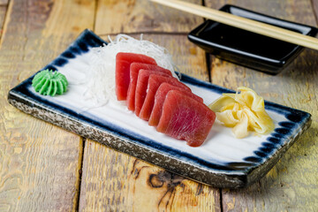 fresh sliced sashimi tuna on wooden table - 479865638