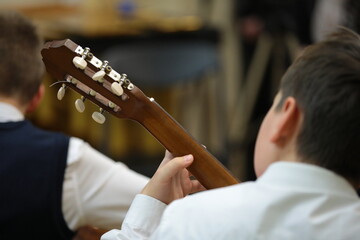 Guitarist playing guitar rear view close-up