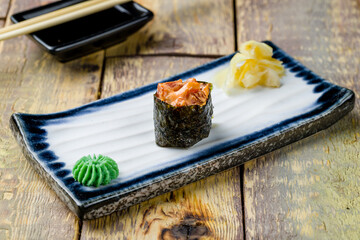 Sushi gunkan with spicy tuna on wooden table