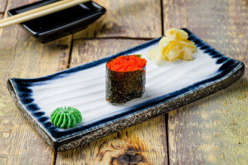 gunkan with masago caviar on wooden table