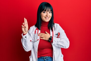Young hispanic woman wearing doctor uniform and stethoscope smiling swearing with hand on chest and...