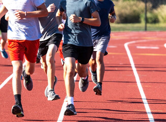 Fototapeta premium Group of boys run training on a track