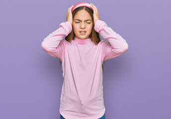 Fototapeta premium Beautiful brunette little girl wearing casual turtleneck sweater suffering from headache desperate and stressed because pain and migraine. hands on head.