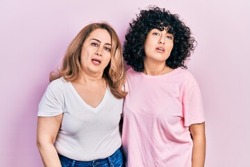 Middle east mother and daughter wearing casual clothes looking sleepy and tired, exhausted for fatigue and hangover, lazy eyes in the morning.