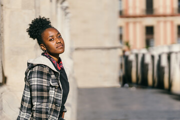 Portrait of a teen african woman facing the camera with serious expression