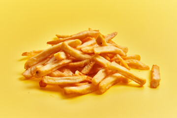  Bunch of french fried potatoes over yellow background