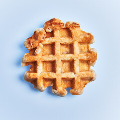  Single delicious waffle over blue background