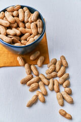 Image of bunch of peanuts in a bowl on a table
