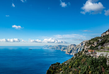 Fototapeta na wymiar View of the Sorrentine Peninsula and Capri along the Amalfi Coast of Italy, with Tyrhennian Sea under blue skies and clouds