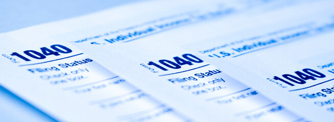Pen on tax form 1040. Business concept. April 2021