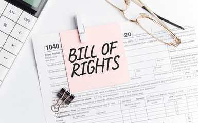 Fototapeta na wymiar BILL OF RIGHTS with pen, calculator, glass and sticker. Tax report sign