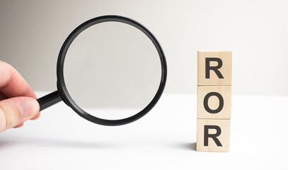 Lettering ROR on wooden cubes on a gray background