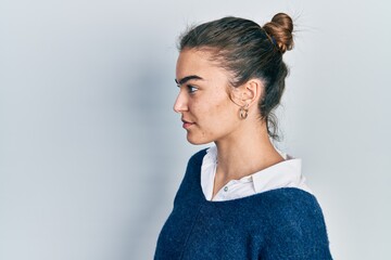 Fototapeta premium Young caucasian girl wearing casual clothes looking to side, relax profile pose with natural face with confident smile.