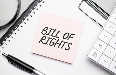 BILL OF RIGHTS. Notepad, eyeglasses and white pen. Financial concept