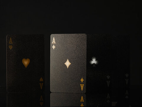 Stylish composition. 3D image - black cards on a black background. Minimalism. Poker game, gambling, night club, casino, online casino, advertising, gambling business.