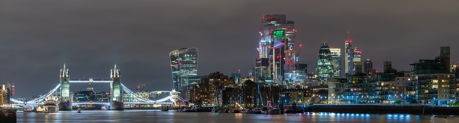 London skyline panorama at night with Tower Bridge and financial district. England