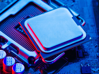 Macro shot of a processor desktop with the contacts facing up on a blue surface. Semiconductor pins and connectors. Modern digital computer technology, computer repair and hardware.