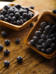 Two bowls of fresh blueberries. Wood texture. Lots of facilities. Wild berries, farming and agriculture, supermarket, market, cooking, vitamins, antioxidants, cooking, pie filling, sauces.