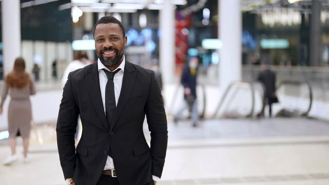 portrait of happy afro-american man in modern metro station, black guy