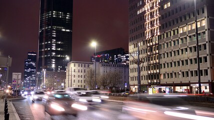 Cityscape in early night time with urban traffic. Street in the city in winter. Fast moving cars © Grand Warszawski