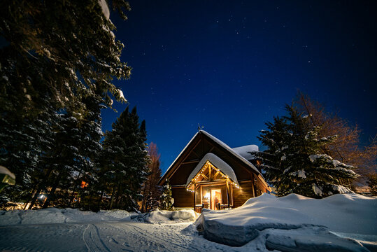 Little Snowy Chalet at Night/ Beautiful log cabin during winter in Mont Tremblant, Quebec, Canada
