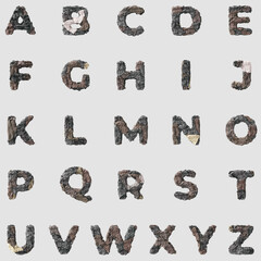 Stone letters alphabet on light background isolated metall rusty thrash foil white background