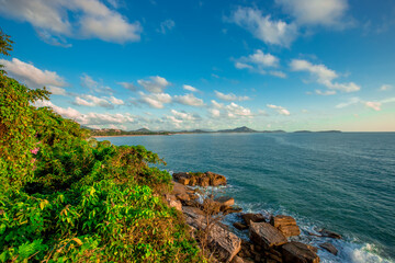 The background of the sea by the evening sea, with natural beauty (sea water, rocks, sky) and fishermen are fishing by the river bank, is a pleasure during travel.