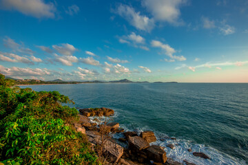 The background of the sea by the evening sea, with natural beauty (sea water, rocks, sky) and fishermen are fishing by the river bank, is a pleasure during travel.