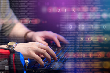 Programmer's hands. Human hands on keyboard. Binary code in foreground. Software development...