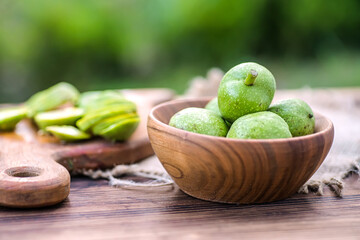 Ingredients for tincture of green walnuts in a wooden ecological plate without chemicals. zero waste. Soft focus