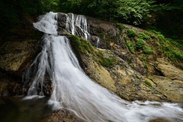 trekking around waterfall in summer