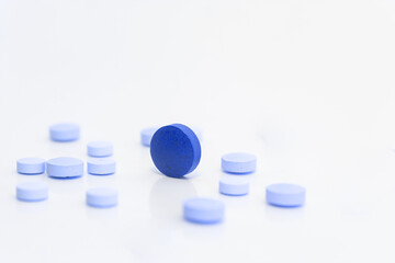 Blue and light blue pills. Concept of male erectile difficulty or medical environment.