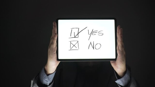 decision concept. business person shows yes or no sign on tablet.