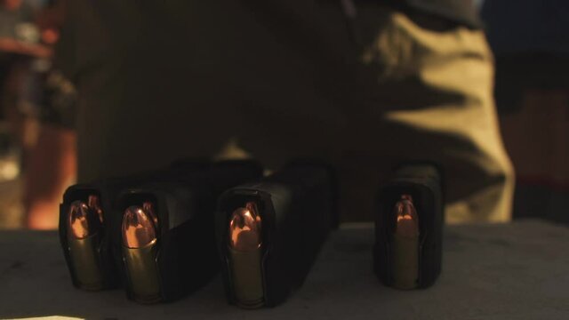 Close up view of four 9mm caliber parabellum bullets magazine of pistol ammunition at a shooting range in Pleasant Valley, USA on 4th July.