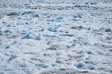 Melting ice on the river in spring. Ice drift time. Natural structure.