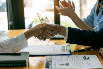 Managers and job seekers shake hands after a job interview. To find people to work with the company...