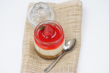 Top view panna cotta with topped strawberry in glass jar