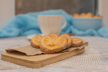 Heart shaped cookies on a wooden stand and a cup of coffee for breakfast.