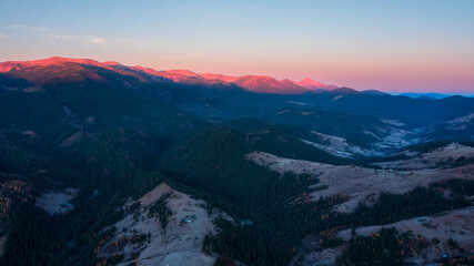 Aerial view of mountain range under sunlight