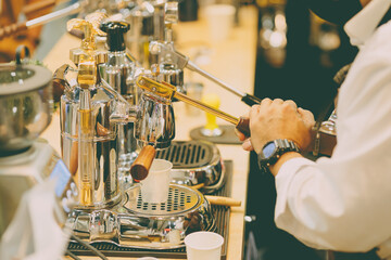 Cafe barista using manual lever espresso coffee extractor hand press machine classy style - obrazy, fototapety, plakaty