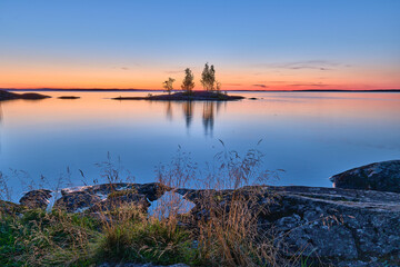 Fototapeta na wymiar Sunset over the lake whit the view of small island
