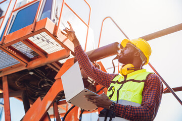 Portrait Black African staff worker happy smile working in cargo crane shipping logistic port.