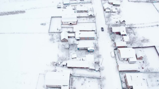Aerial top down drone shot of Snowy village road and car on it. Forest road from above. White background. Diagonal highway. Minimalism concept 4k video