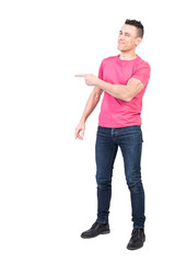 Cheerful man pointing aside in studio. White background