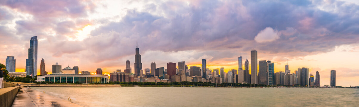 chicago,illinois,usa. 8-11-17: Chicago skyline at sunset with cloudy sky and reflection in water.