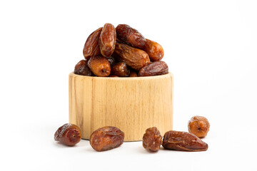 Dried dates in wooden bowl isolated on white.