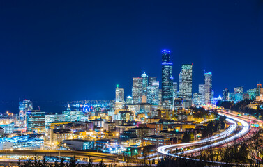 Fototapeta na wymiar Seattle skylines and Interstate freeways converge at sunset, Seattle, Washington, USA.