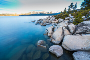 beautiful Lake tahoe at sunrise with reflection in water.