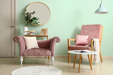 Interior of living room with pink armchairs and tables